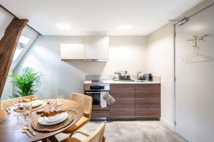 a kitchen and dining room with a table and chairs at Family penthouse 7-Minutes from Rotterdam Central Newly Build top floor terrace R5 in Schiedam +20 photos