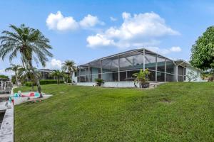 a large house with a large lawn in front of it at Sun & Smiles in Cape Coral