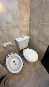 a bathroom with a toilet and a sink at Departamento Centrico in Villa María