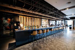 a bar with a row of stools in a room at Sage Melbourne Ringwood in Ringwood