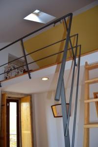 a loft bed in a room with a ceiling at Retiro da Lameira in Seia