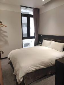 Postel nebo postele na pokoji v ubytování Yi Su Hotel-Taipei Ningxia
