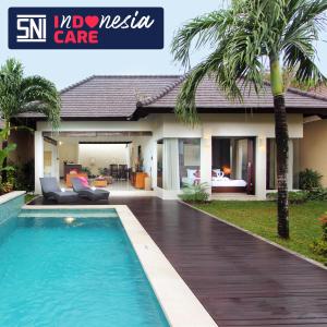 a house with a swimming pool in front of a house at RC Villas and Spa Bali in Seminyak