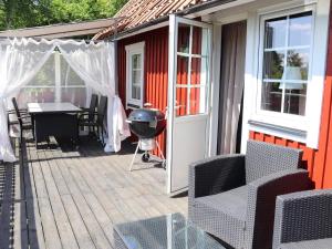 a patio with a grill and a table and chairs at 4 person holiday home in MUNKA-LJUNGBY-By Traum in Munka-Ljungby
