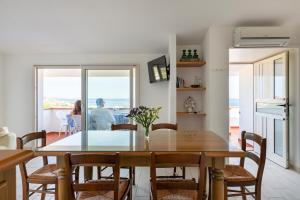 a dining room with a table and a view of the ocean at Residence Biriola EcoResort in Cala Gonone