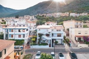 a city with cars parked in a parking lot at Biriola EcoResort Cala Gonone in Cala Gonone