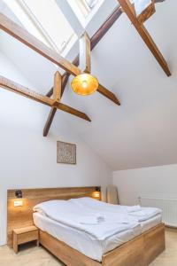 a bedroom with a bed and a ceiling fan at Magtár Villa in Bóly