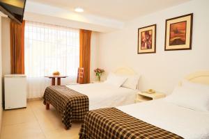 Postel nebo postele na pokoji v ubytování Astorga Hotel Arequipa