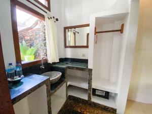 a bathroom with a sink and a mirror at Sayang Mama Inn in Gili Islands