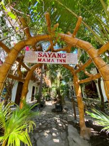 a sign that says saving mama inn under a tree at Sayang Mama Inn in Gili Islands