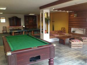 a living room with a pool table and a room with a pool table at Auberge d'Imsthal in La Petite-Pierre