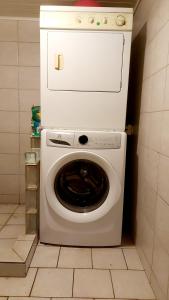 a white washer and dryer in a kitchen at Tokerau Tahiti in Pirae