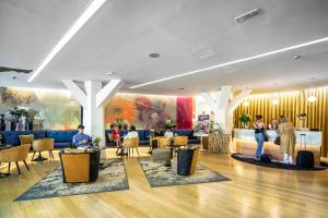 a lobby of a hotel with people standing in the lobby at Apartosuites Jardines de Sabatini in Madrid