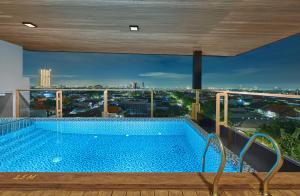 a swimming pool on the roof of a building at Aston Inn Jemursari in Surabaya