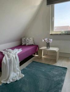 a bedroom with a purple bed and a purple rug at Apartment Miesmuschelparadies in Lübeck
