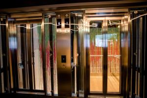 a group of glass doors in a building at Motel One Graz in Graz