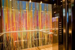 a glass wall with many different types of items at Motel One Graz in Graz