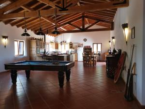 a pool table in the middle of a room at Monte da Bela Vista - Luxury Villa 10 mins from best beaches in Portugal in Pedreneiras