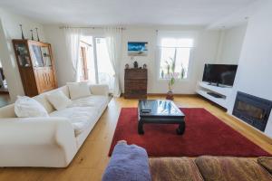 een woonkamer met een witte bank en een salontafel bij Apartamento con terraza in Tarifa