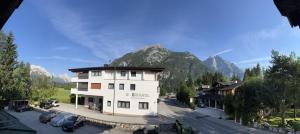 a large white building in front of a mountain at Weidach Bergblick in Leutasch