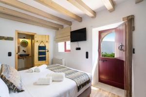 a bedroom with a bed and a window and a door at Charming Cretan Villa near Sitia 
