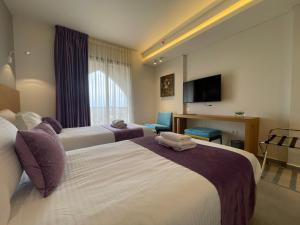 Postel nebo postele na pokoji v ubytování Majestic Byblos Grand Hotel