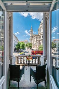 a balcony with two chairs and a view of a city at Jacuzzi Basilica view in Budapest