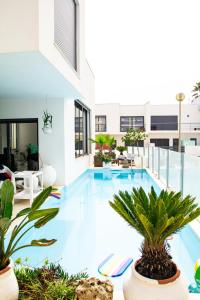a large swimming pool in a building with plants at Villa Secret Spot Luxury in Lourinhã