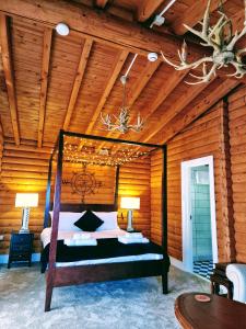 een slaapkamer met een bed in een houten kamer bij Kaoglen-Stags-Hot tub-Cairngorms-Pet Friendly in Balnald