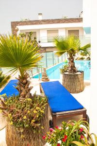 a patio with a blue table and some plants at Villa Secret Spot Luxury in Lourinhã