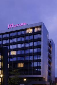 a large building with a large clock on it at Mercure Hotel Groningen Martiniplaza in Groningen