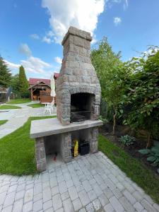 a stone pizza oven sitting on a patio at Apartamenty Nadbrzeżna Premium 2 in Augustów