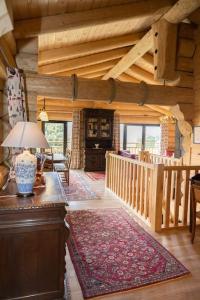 a living room with a staircase in a log cabin at Les Flocons de Neige in Bolquere Pyrenees 2000