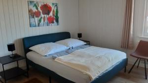 a bed with two pillows on it in a bedroom at Ferienhaus Lotte in Zerpenschleuse