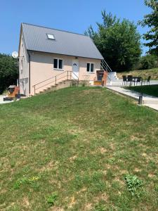 a house with a large yard in front of it at Hibiskus Appartementhaus in Cserszegtomaj