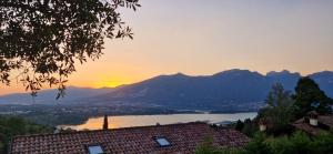 a view of a lake and mountains at sunset at Villa Fiesta in Oggiono
