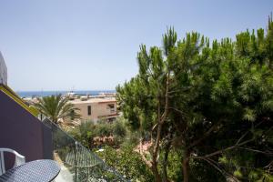 a balcony with a view of a palm tree at Flora Maria Hotel in Ayia Napa