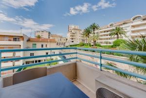 einen Balkon mit einem Tisch und einige Gebäude in der Unterkunft Residhotel Les Coralynes in Cannes