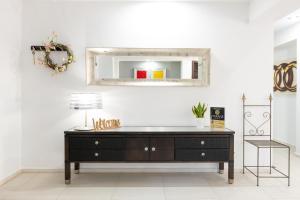 a room with a dresser and a mirror on the wall at Marane Deluxe House in Ialyssos +12 photos