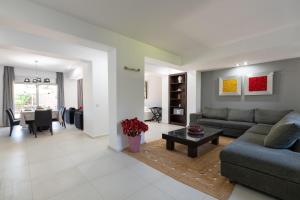 a living room with a couch and a table at Marane Deluxe House in Ialyssos