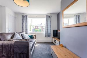 a living room with a couch and a window at Luke Stays - Sea View in Hirst