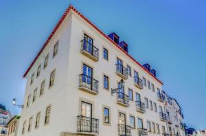 a white building with balconies on the side of it at Casas da Baixa - dAmouraria in Lisbon