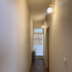 a hallway with a room with a window and a door at TOMO B&B in Taitung City