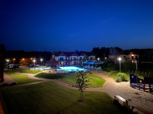 park w nocy z domem i basenem w obiekcie Apartament Łebska Ostoja w mieście Żarnowska