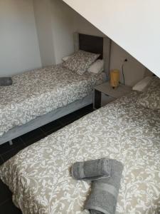 a bedroom with two beds and a night stand at Aldea Bricia 20 BC in Posada de Llanes