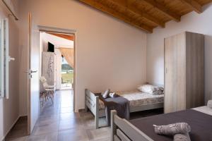 Ένα ή περισσότερα κρεβάτια σε δωμάτιο στο Casa Alati