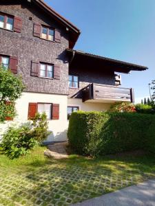 a house with bushes in front of it at Ferienwohnung Heidi mit Oberstaufen PLUS in Oberstaufen