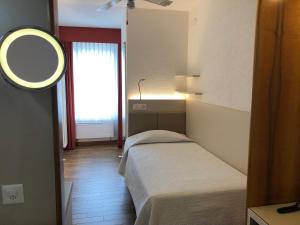 Voodi või voodid majutusasutuse Hotel Campione toas