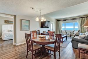 a dining room and living room with a table and chairs at Atlantic Ocean View Condo with Private Balcony and Access to Beachside Pool condo in Fernandina Beach