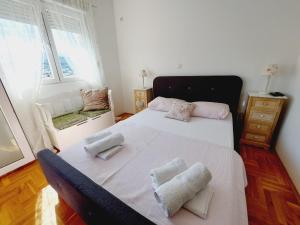 a bedroom with a bed with two pillows on it at Aska Apartment in Bar